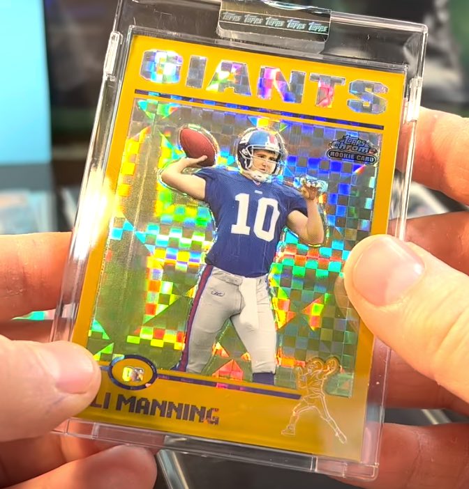 An Eli Manning rookie card with a clearly visible line on the card's left side